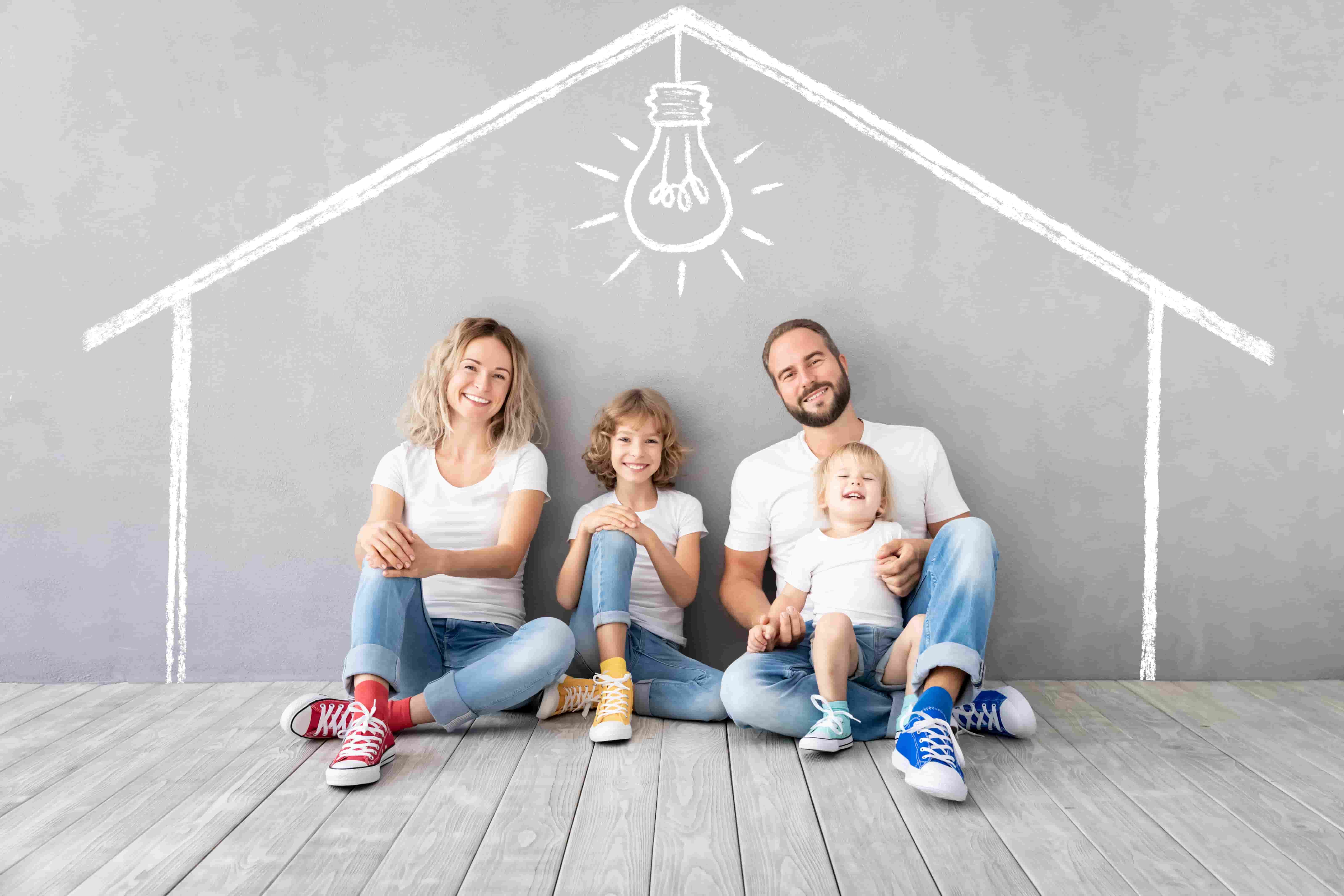 Happy family with two kids playing into new home. Father, mother and children having fun together. Moving house day and real estate concept